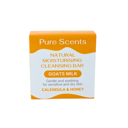 A square bar of natural moisturising goats milk soap with calendula and honey. The bar has a orange and white label.